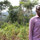 Chief Edwin Ogar-standing in front of the Ekuri community forest.